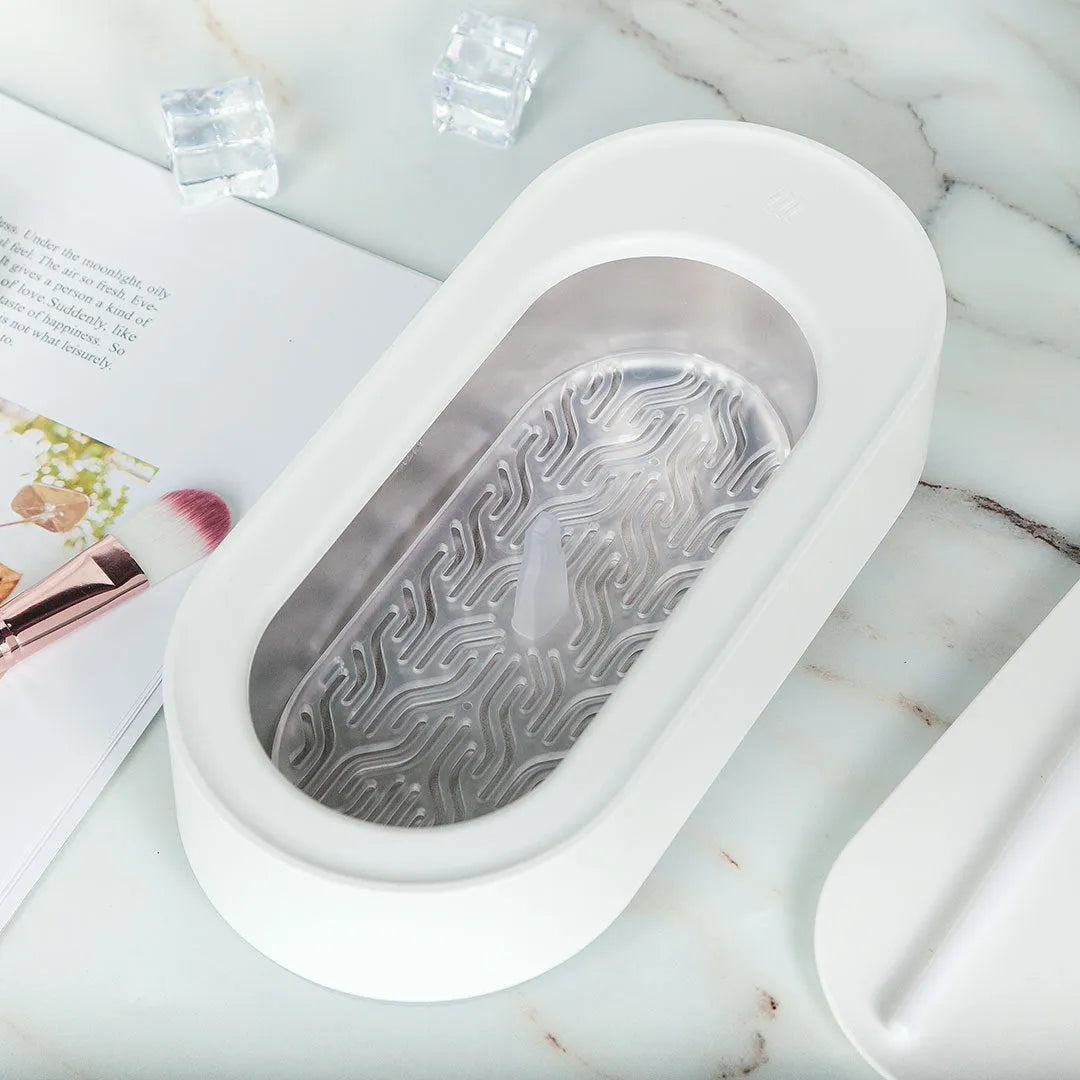 White portable ultrasonic cleaning machine with stainless steel tank and touch button.