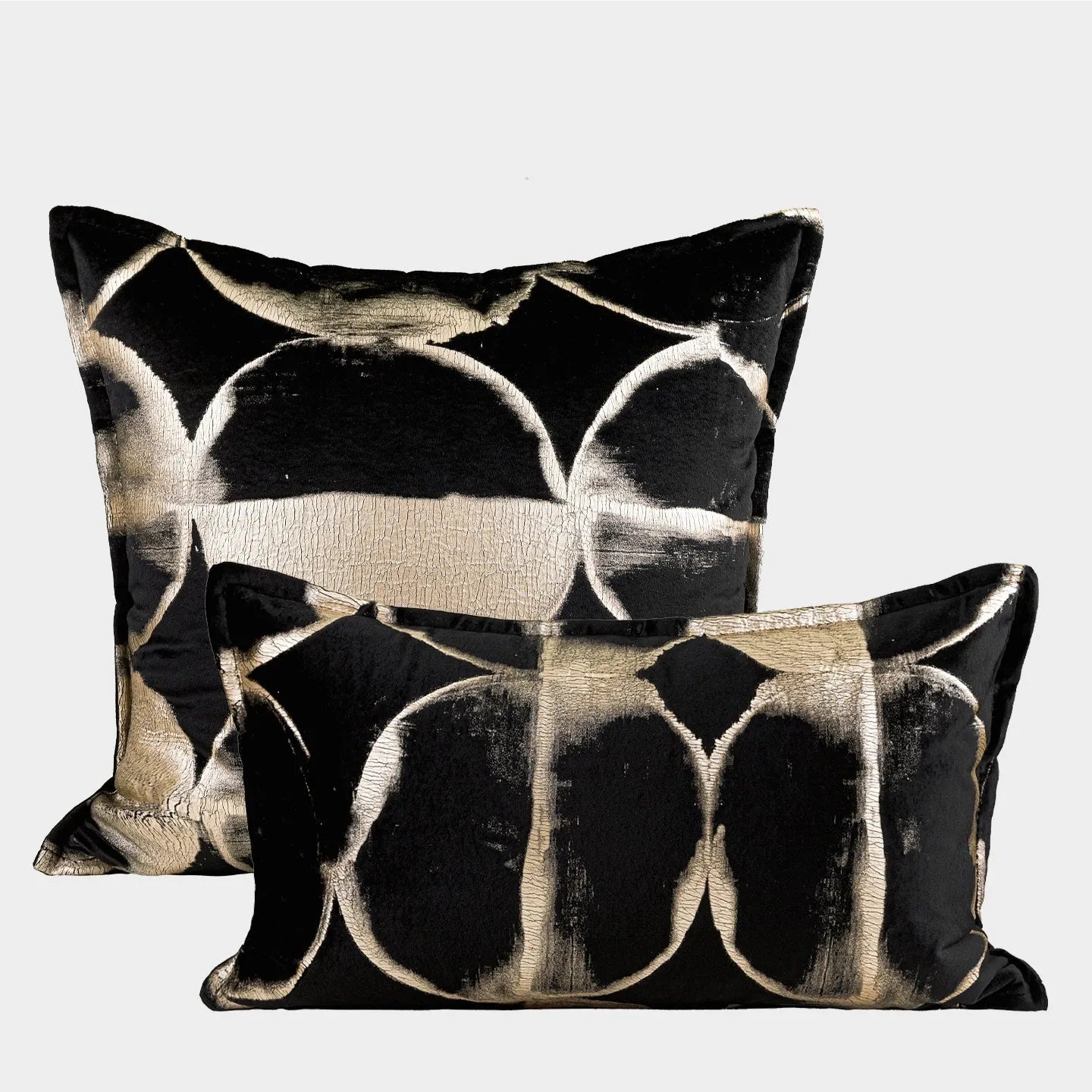 Black and gold abstract pattern cushion with flannel cover on a grey sofa