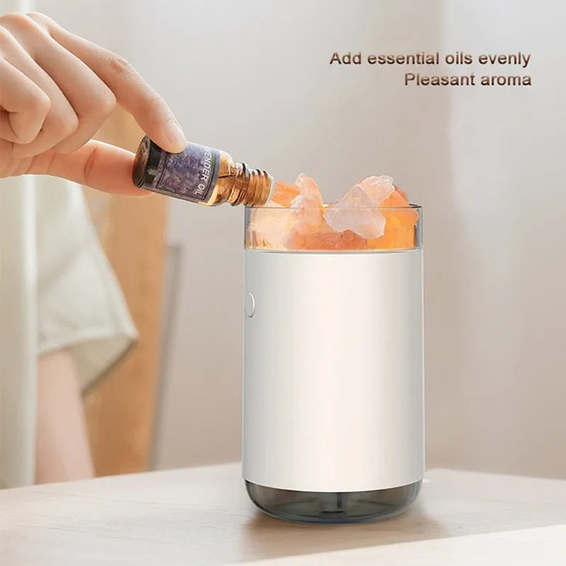 Ultrasonic aromatherapy diffuser humidifier with natural crystal salt stone and LED lamp in blue, showing mist and light