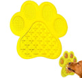 Blue silicone dog licking mat with bone texture and suction cups on a tiled wall