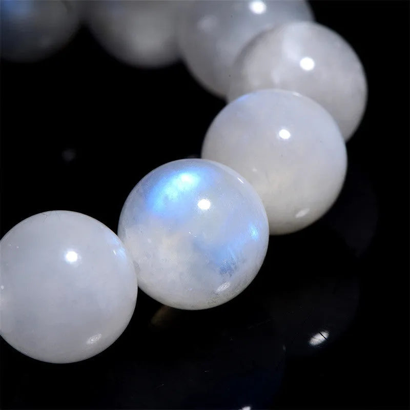 Natural blue moonlight round bead moonstone bracelet with geometric shape on a wrist.