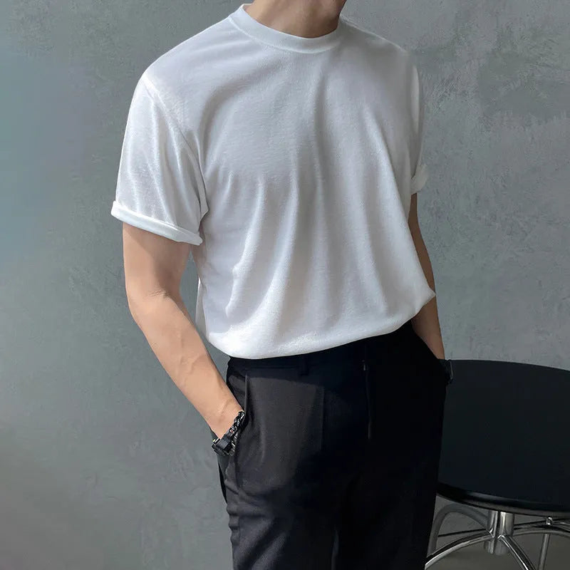 Men's slim fit solid colour cotton t-shirt on a model, showing round neck and half sleeves in white or black.