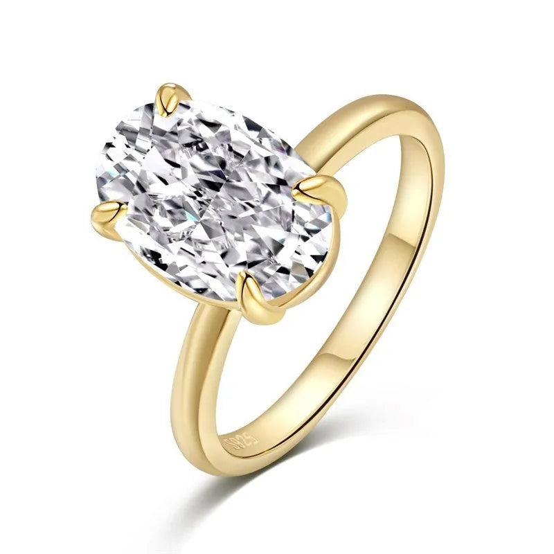 Women's oval silver ring with a four-claw setting holding a hand-cut gemstone.