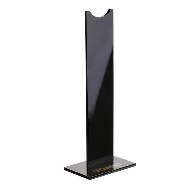 Pink detachable gaming headset stand with non-slip silicone base on a desk