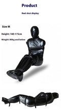 Black patent leather full coverage body restraint wrap with six ratchet tie down straps.
