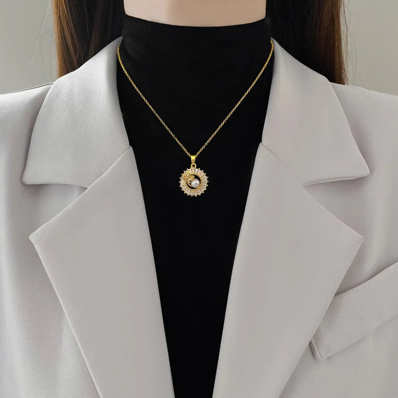 Women's geometric jewellery set with square diamond accents, ring and leaf motif on necklace and matching stud earrings.