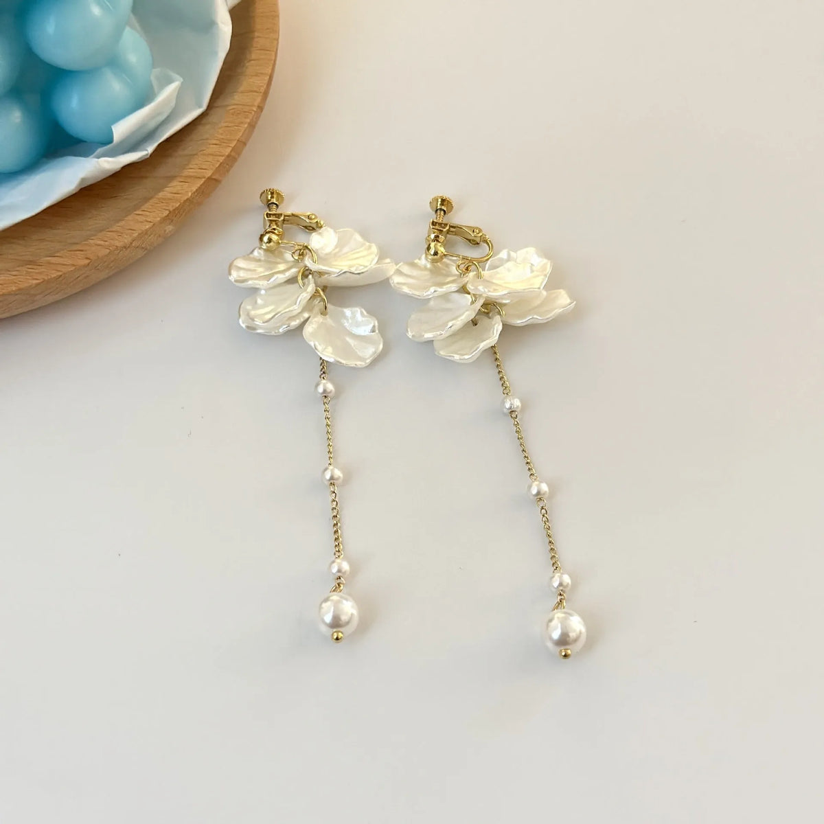 Women's acrylic shell pearl tassel earrings showing 8.8cm length and tassel design