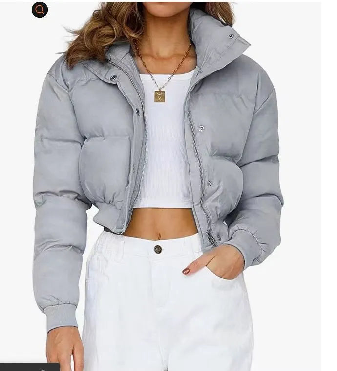 Women's loose blue polyester jacket with long sleeves on a hanger