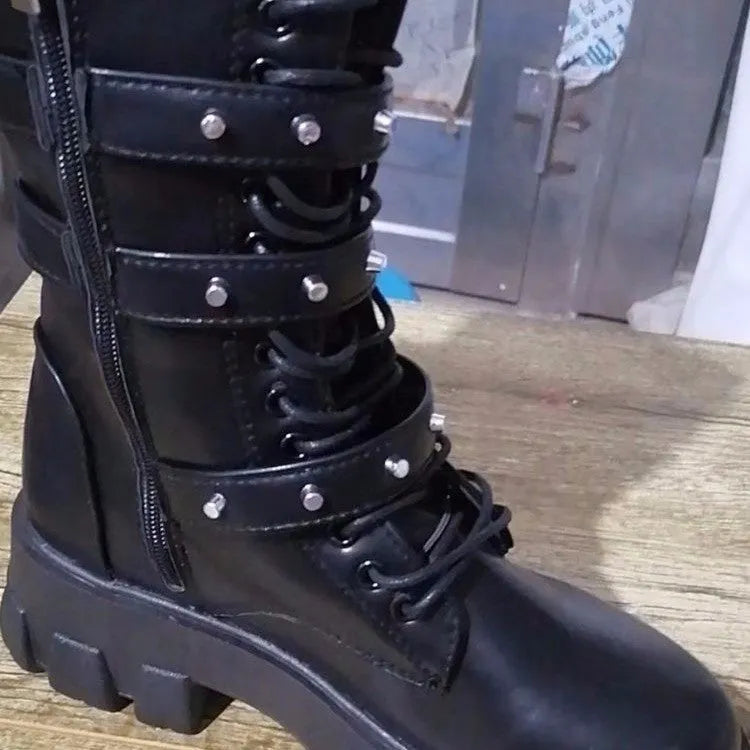 Women's black mid-calf buckle boots with side zipper and round toe, showing metal buckle detail