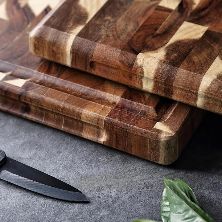 Brown acacia solid wood chopping board with parquet design, 3cm thick, on a kitchen counter