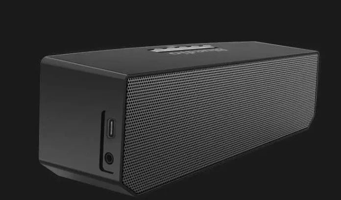 Black Bs-6 Bluetooth smart speaker on a desk showing its compact rectangular form.