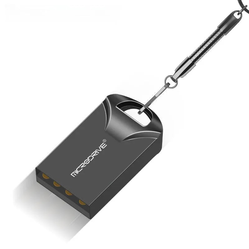 Small black and silver metal USB flash drive showing compact size next to a ruler for scale