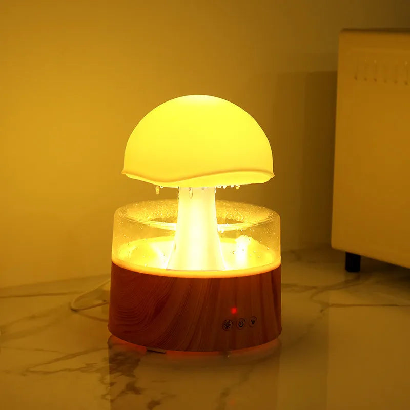 White cloud-shaped aromatherapy humidifier with LED lights and simulated raindrops.