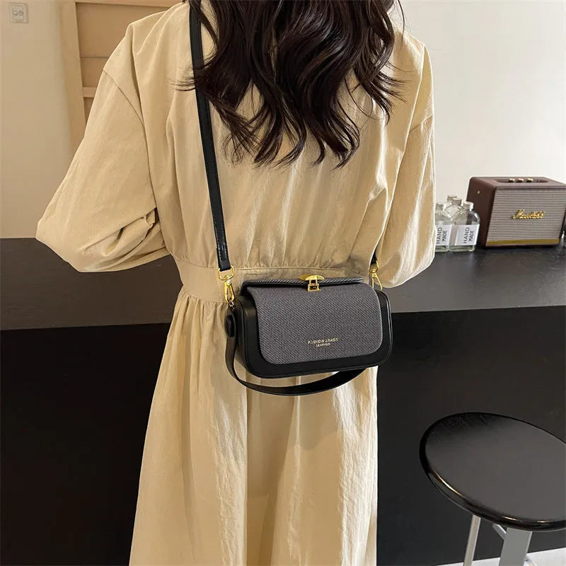 Women's black PU leather messenger bag with contrast stitching and a lock detail.