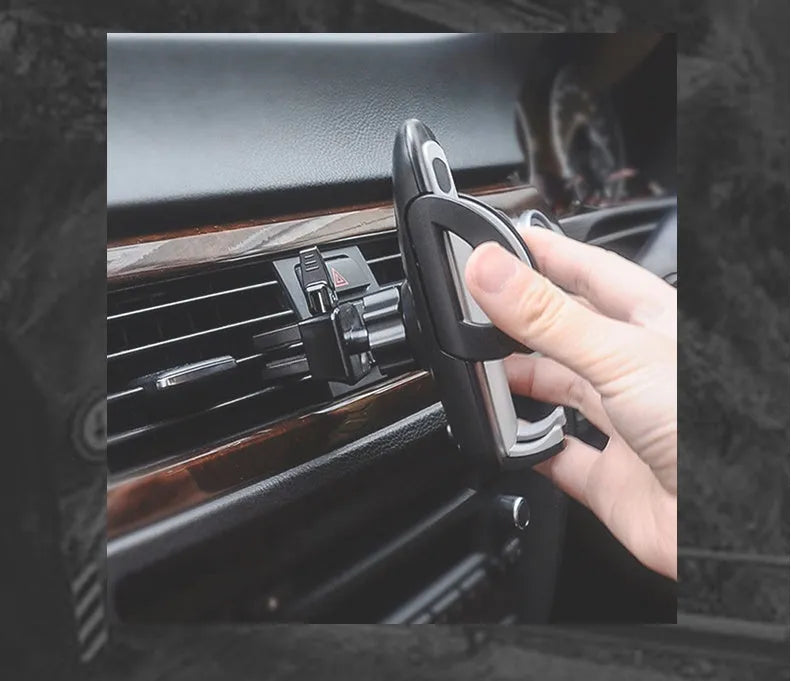 Universal black plastic car air vent mobile phone holder mounted on a car dashboard.