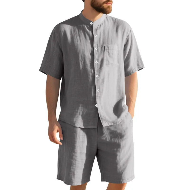 Man wearing a light blue short sleeve linen shirt jacket and matching shorts, a two-piece summer suit.