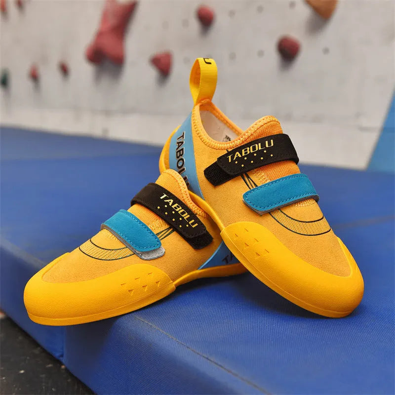 Men's and women's black beginner rock climbing shoes with coloured accents and Velcro strap