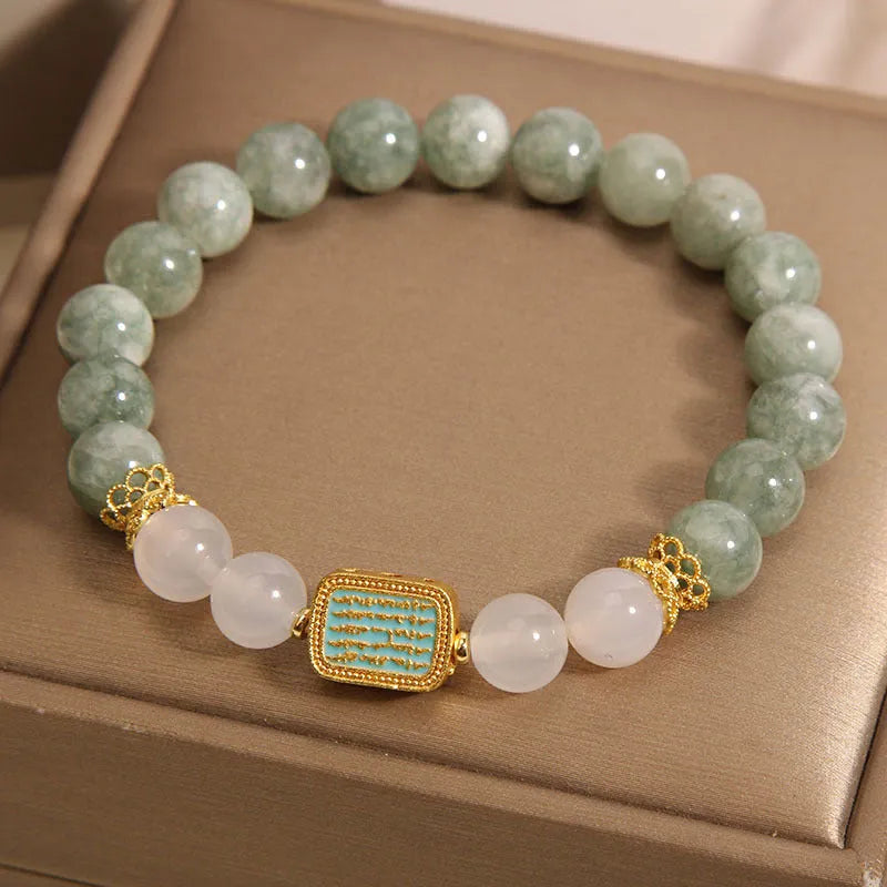 Women's oil green emerald crystal bracelet showing five scripture elements on wrist