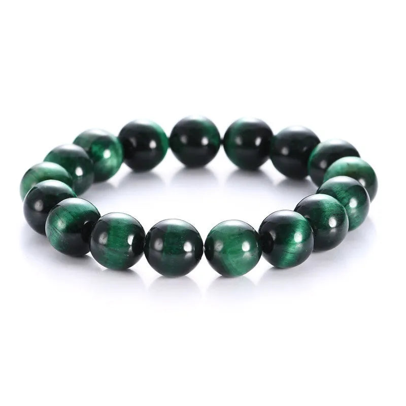 A green tiger eye stone beaded bracelet with geometric polished beads on an adjustable cord.