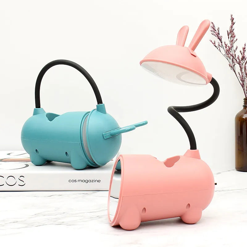 Cartoon-themed USB desk lamp with built-in pen container in green, dark blue, or pink colour options
