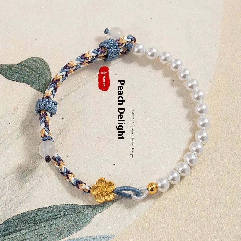 Peach-coloured Chinese flower weaving carrying strap bracelet with pearl accents on cord material