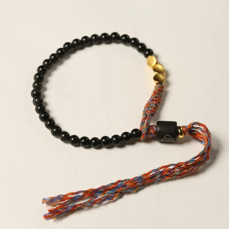 Hand-woven obsidian carrying strap bracelet with textured finish on wrist