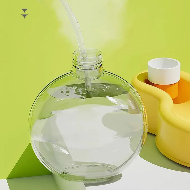 Green portable pet travel cup with handle, showing pull-out drinking bowl for dogs.