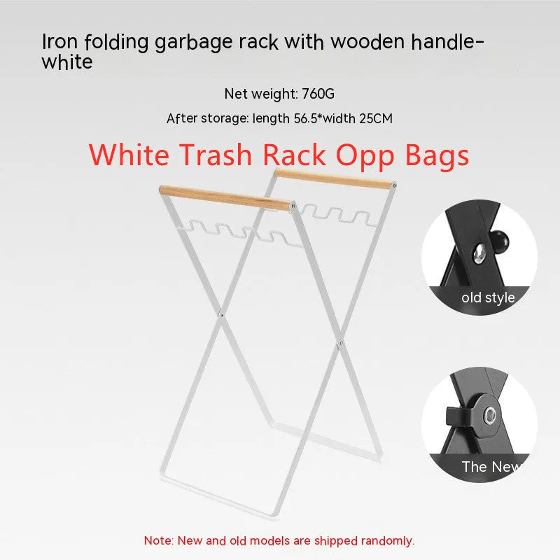 Black iron folding trash rack with wooden handle holding a bin bag outdoors.
