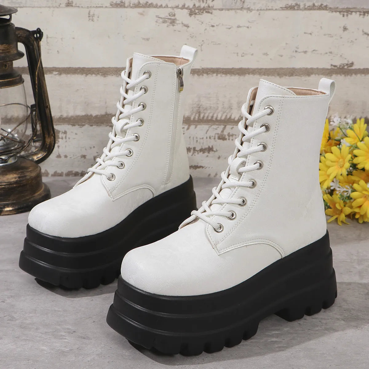 Women's white retro platform Martin boots with side zip and chunky heel on a plain background.