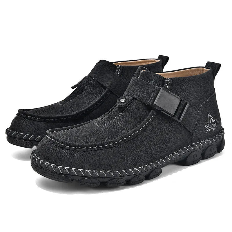 Men's black handmade stitching slip-on loafers with a flat heel on a wooden floor.