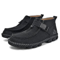 Men's black handmade stitching slip-on loafers with a flat heel on a wooden floor.