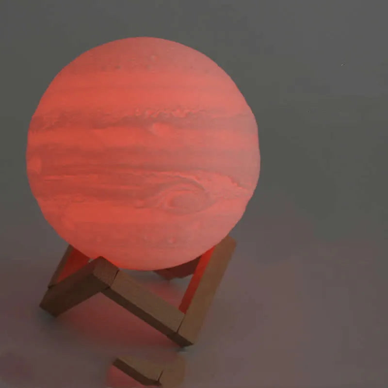 3D printed white moon lamp with detailed craters on a wooden stand, showing touch ring at base