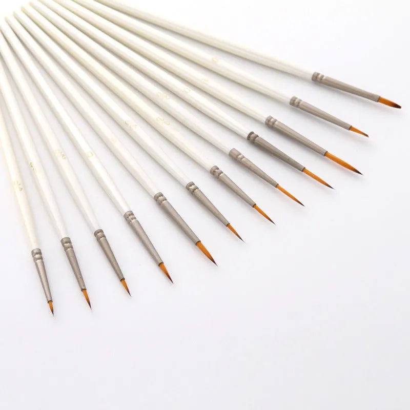Set of 12 Pearl White artist paint brushes with nylon wool bristles, metal ferrules, and wooden handles.