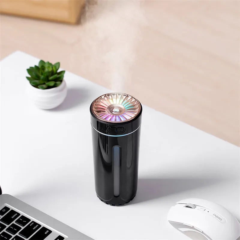 Black portable USB humidifier with colourful lights on car dashboard