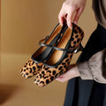Women's black square toe stiletto ankle-strap shoes with a horse hair upper and buckle fastening.