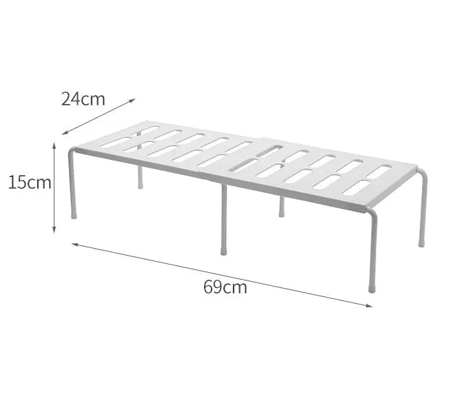 White telescopic plastic kitchen rack extended to 69cm height on kitchen countertop