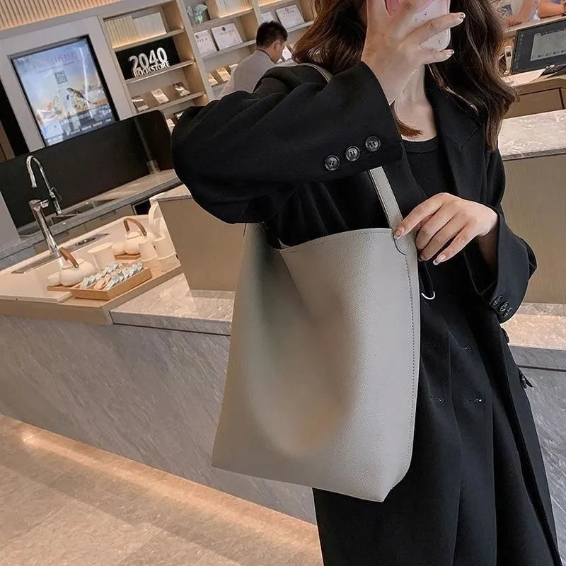 Casual PU shoulder bag for women with visible sewing thread detail in black
