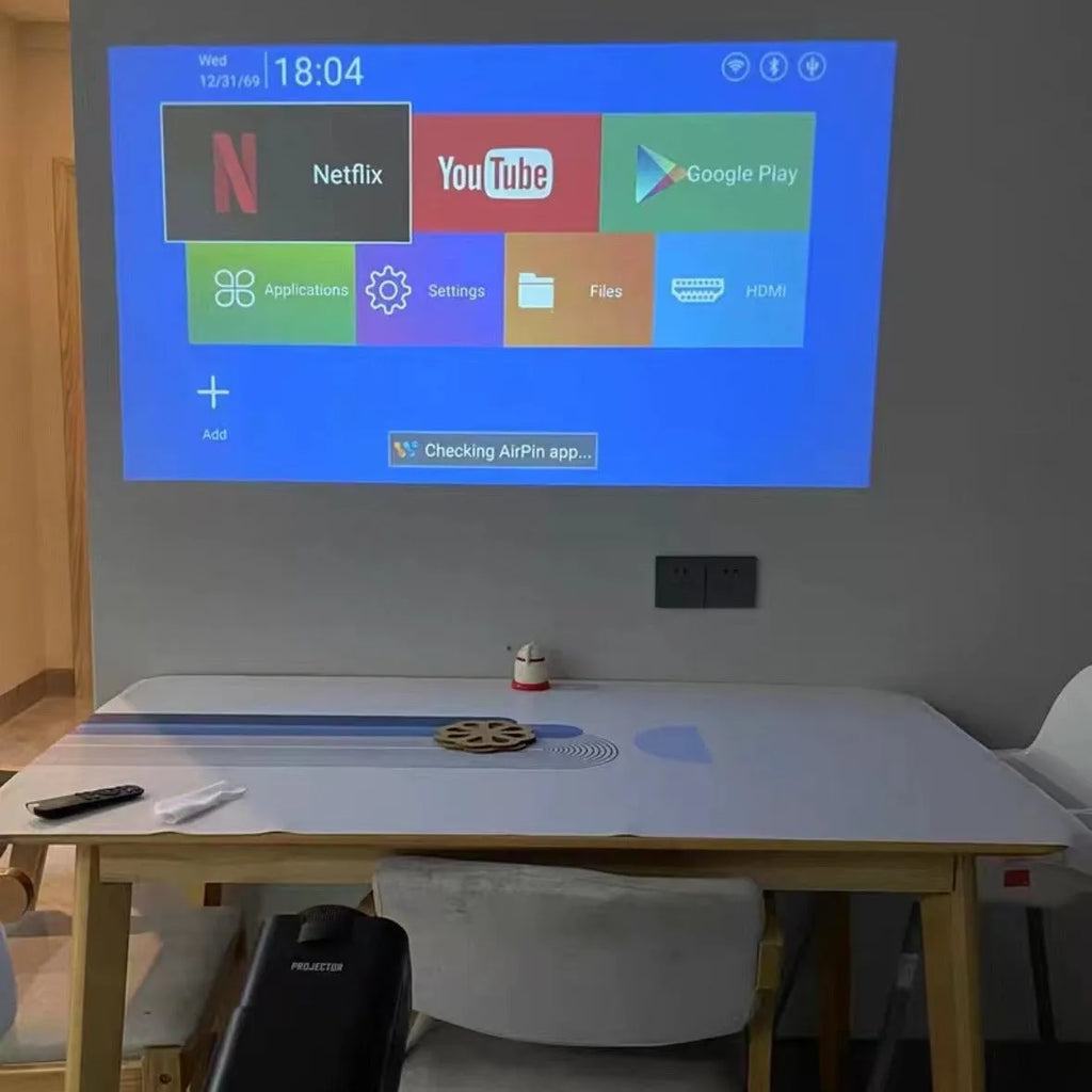 Home projector unit with carrying handle showing 720p HD and wireless projection features