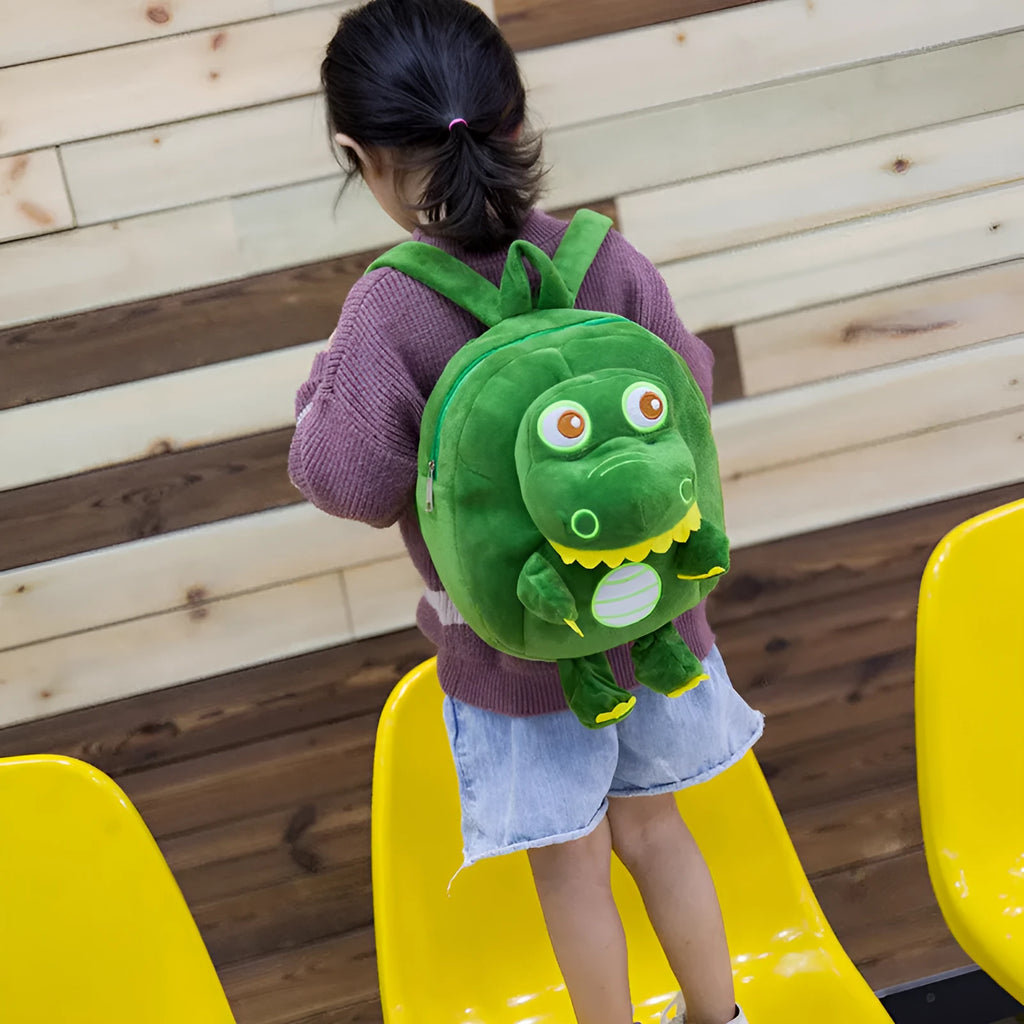 Soft blue dinosaur plush backpack with embroidered details and a soft handle.