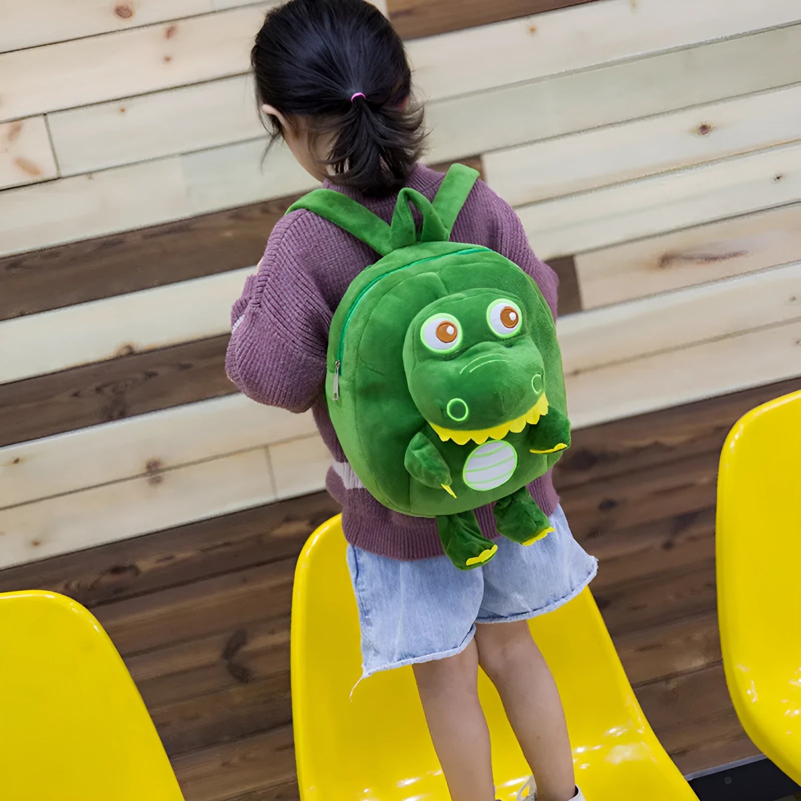 Soft blue dinosaur plush backpack with embroidered details and a soft handle.
