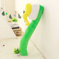 Cartoon toothbrush plush pillow 90cm in blue, green, pink, and yellow on a bed