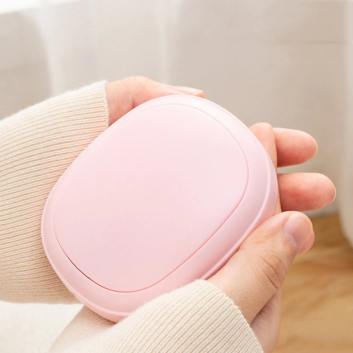 Compact USB hand warmer in pebble shape with single side heating, available in pink blue green beige colours