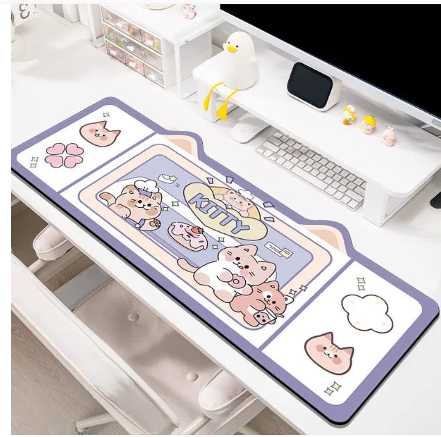 Oversized solid colour desk pad with optional pink bunny, purple bear, or purple kitten patterns on natural rubber base.