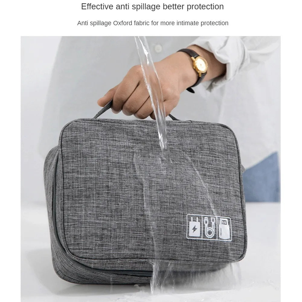 Black waterproof electronics travel cable organizer bag with mesh pockets and top handle