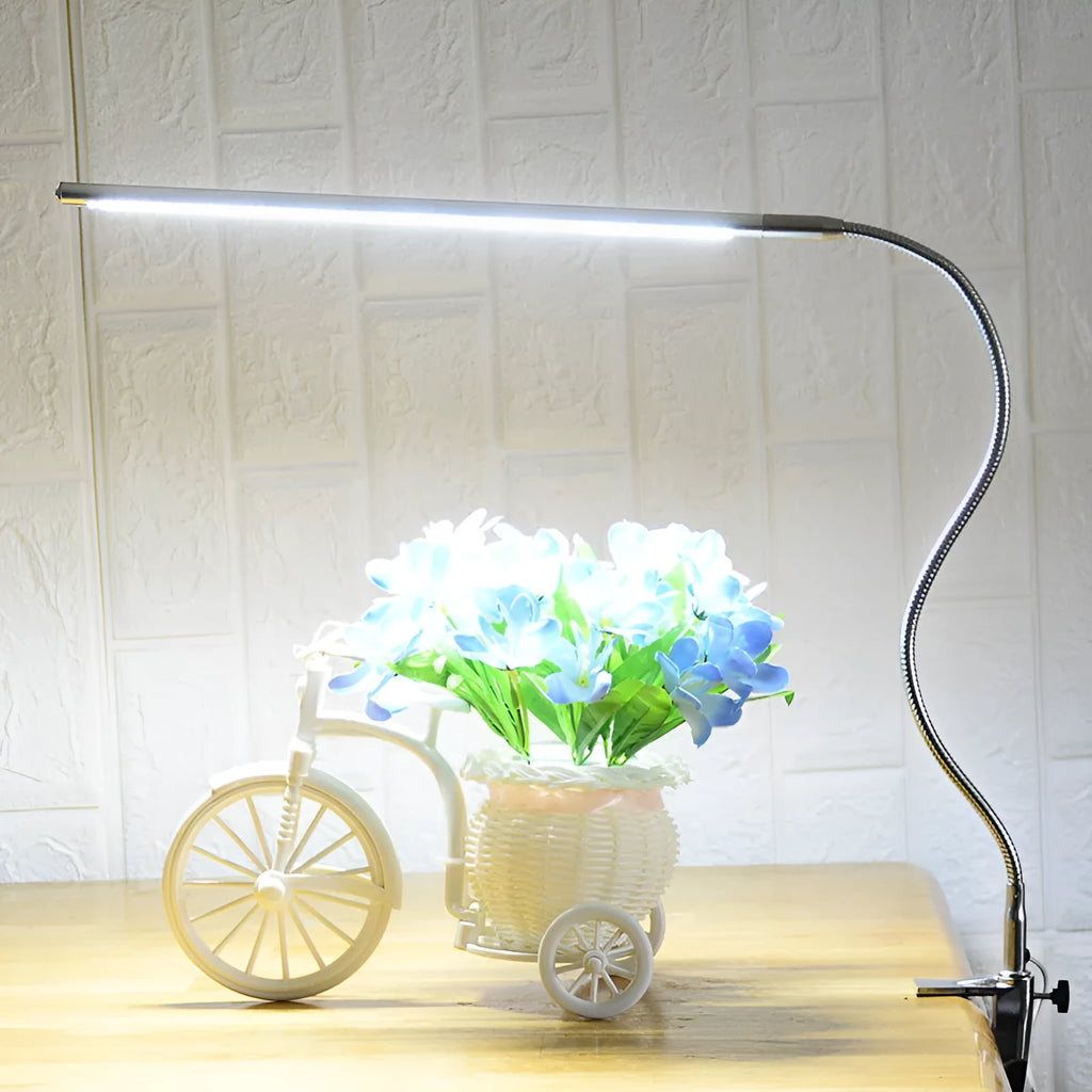 Silver aluminium LED nail lamp with long adjustable arm and clip mounting for workstation illumination