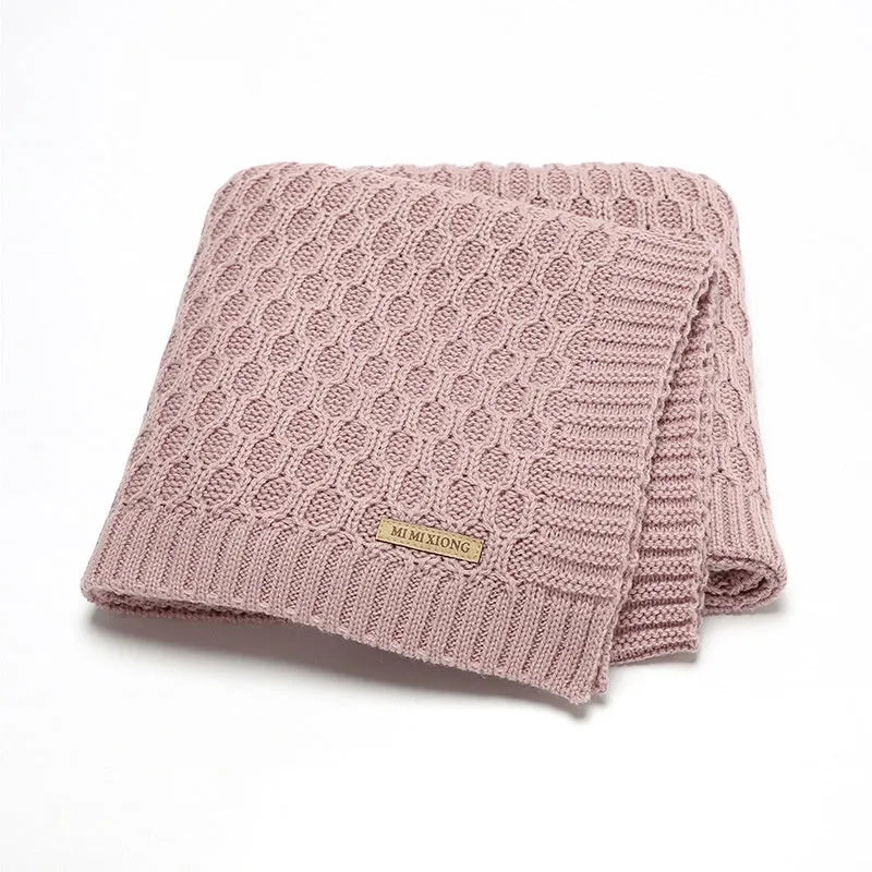 Solid colour infant hug blanket with textured lines in acrylic fabric