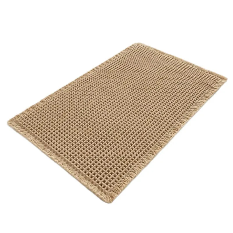 Checkered patterned non-slip absorbent bathroom floor mat in a neutral colour on tiles.