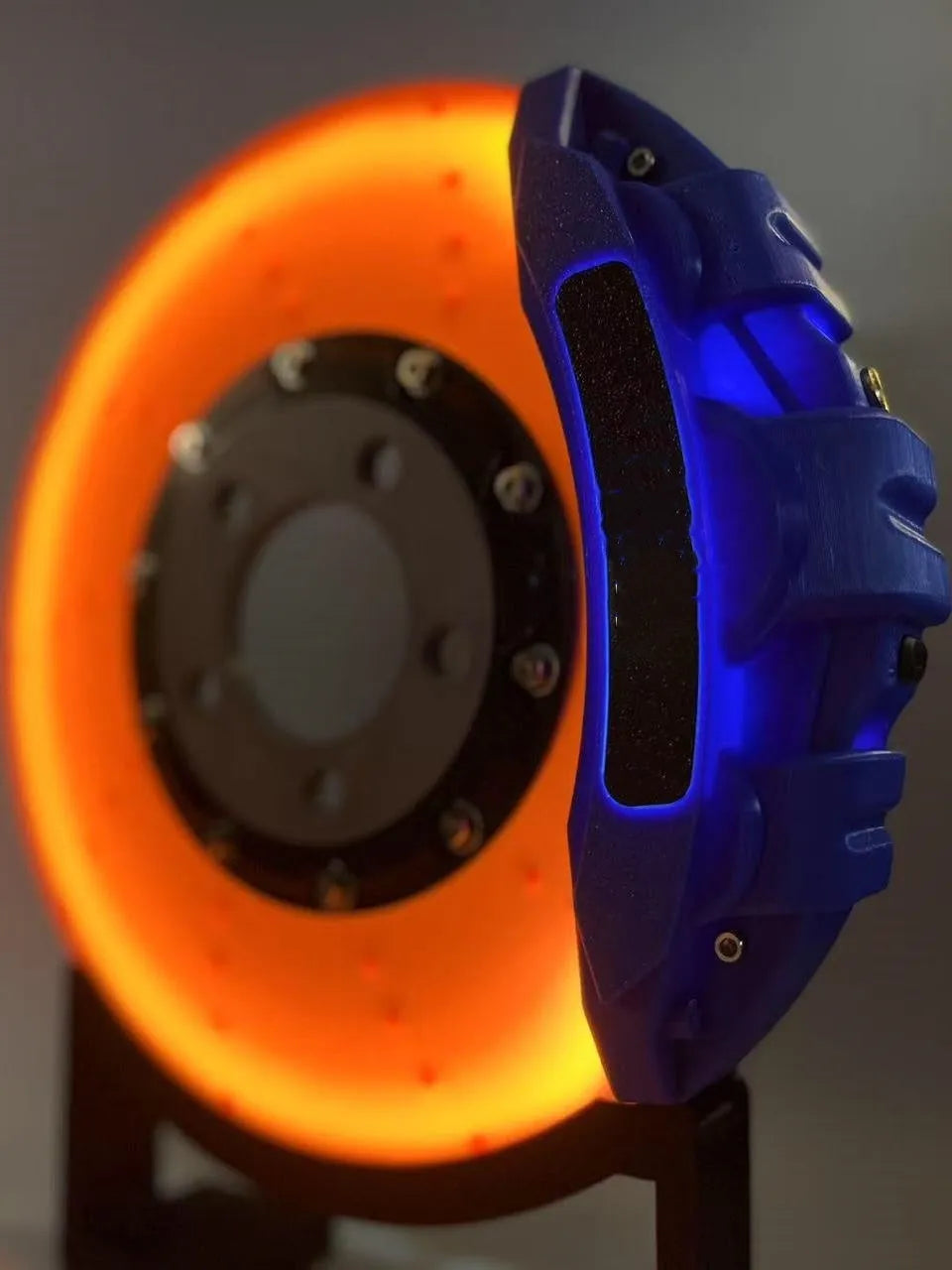 Blue brake disc LED night light with bracket on desk, showing 24cm disc and touch switch