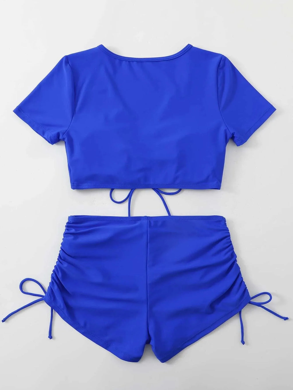 Women's lace-up bow swimsuit top with matching shorts in dark green.