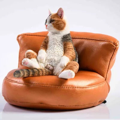Lazy cat ornament with sofa on car dashboard, 7.5cm high resin model with fabric art details